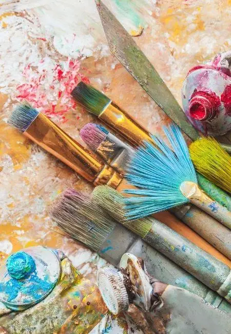 Paintbrushes and colourful palette in Lana Almouakeh's studio