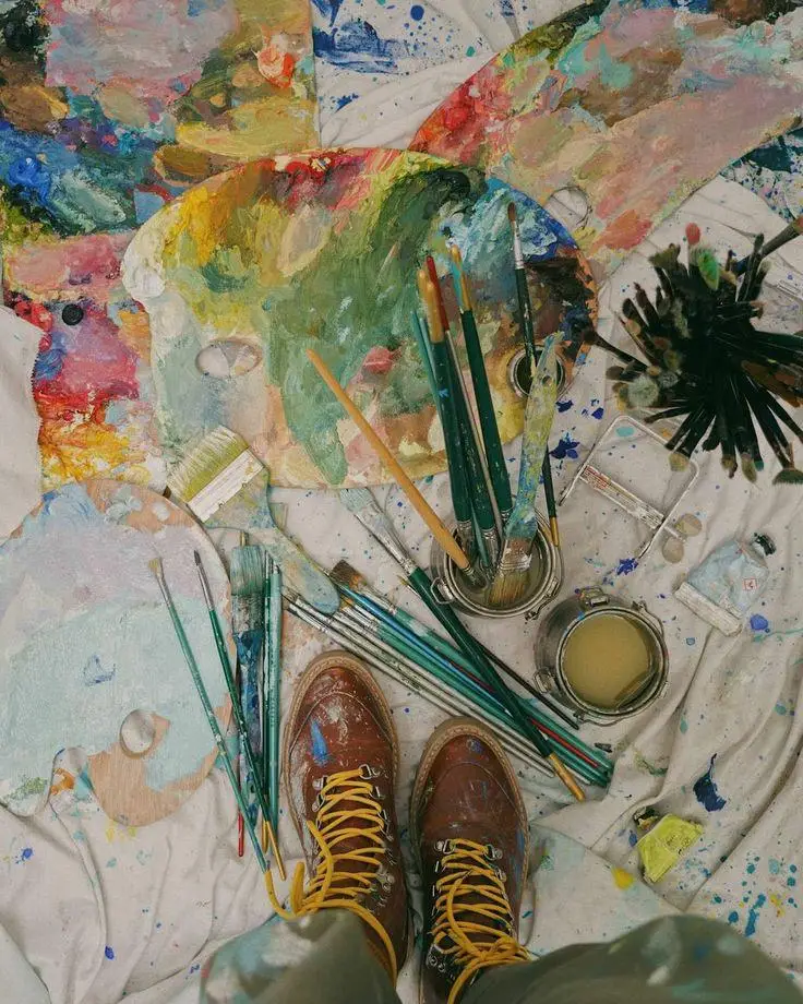 Paint-splattered studio floor and palette in the artist's studio